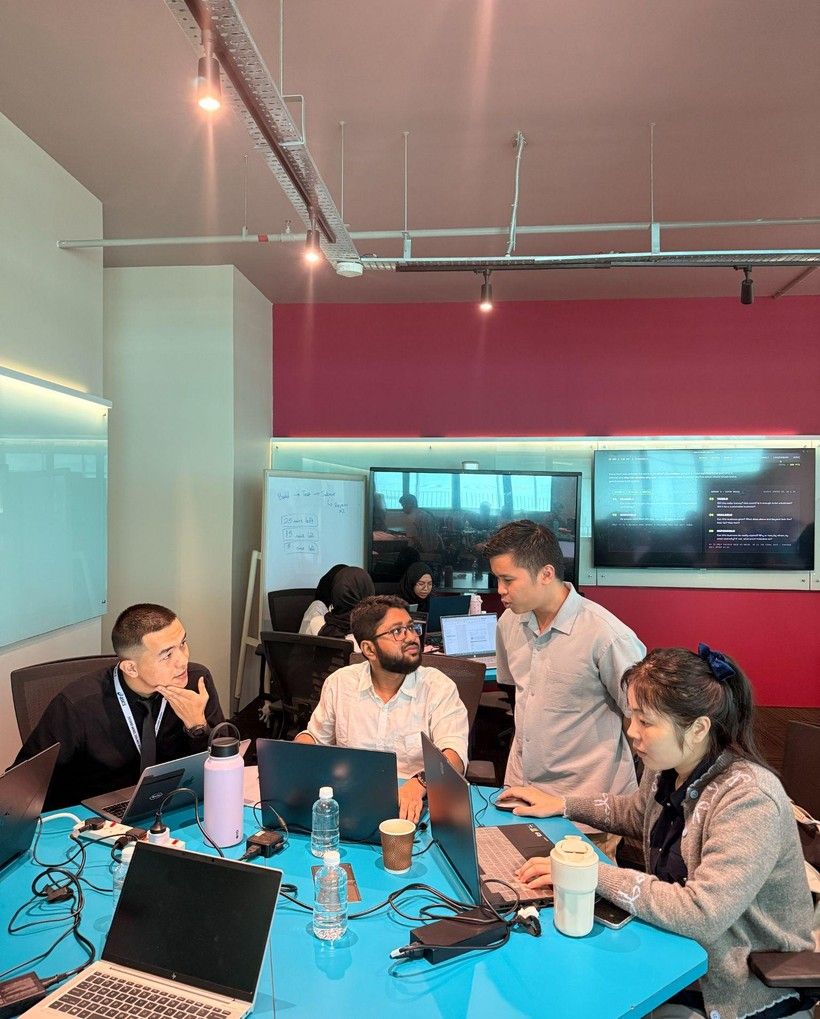 A CIPTA team working through a problem at their laptops